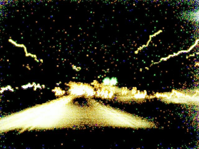 a road at night, 
blurrily, with streaks and spots of light.